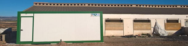 It can be a prefabricated cabin like the ones used in the construction sites, with its entrance on one side and the exit on another side