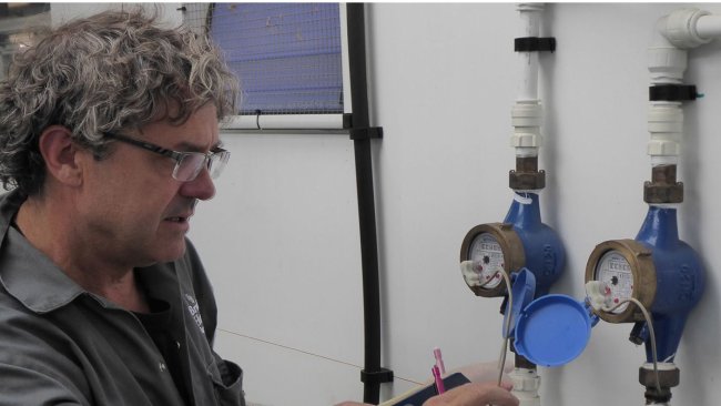 Tim Miller checks the calibration on of water meters on a Midlands pig farm.