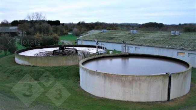 Figure 2. Picture of the installation for the biological removal of nitrogen by means of NDN on a swine farm. In the foreground is the denitrification lagoon/reactor and behind it is the nitrification lagoon/reactor, where the aeration system can be seen.