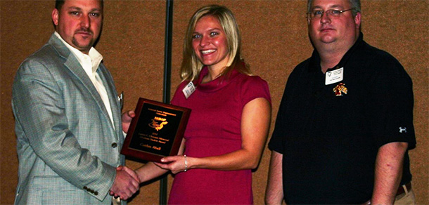 Clint Schwab, President of the National Swine Improvement Federation, congratulates Caitlyn Abell as the winner of the 2011 Lauren L Christian Graduate Student Award. Abells major professor Ken Stalder was surprised and pleased that the organization recognized her accomplishments early in her doctoral program
