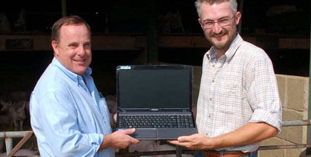 Stuart Mayhew (right) is presented with the laptop computer by Tim Clarke, ACMC’s national sales manager.